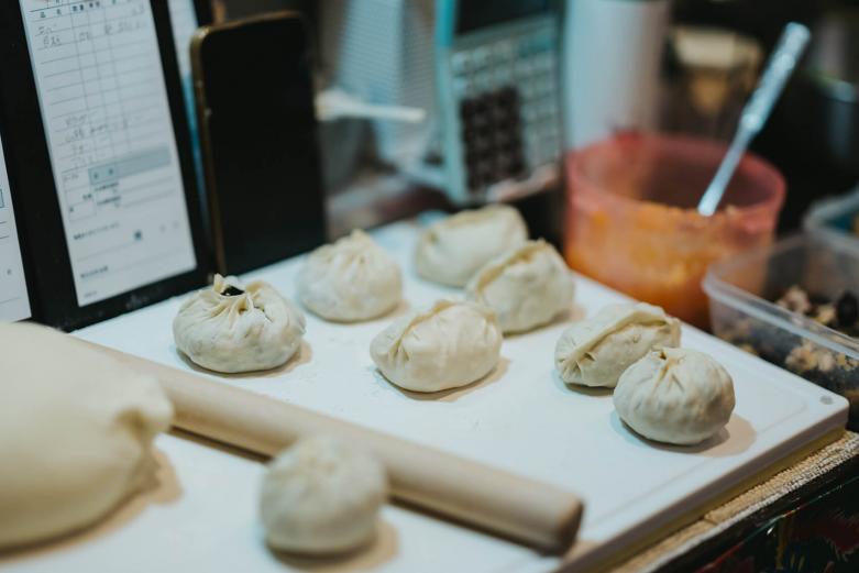 <span style="font-size:12px;"><font color="ffffff"> 餃子は生地から餡まですべて手づくり。そして仕込みから調理まで、すべてをひとりでこなします。<br> <br> 日替わりの餃子はなんと常時10種もの品揃え。季節に応じて地元・大分の食材がふんだんに取り入れられているのが特徴です。例えばこの日の餃子には合鴨や貝柱、牡蠣、なんとロバまでありました。<br> <br> 大学時代に谷崎潤一郎の作品を研究し、その美しい文体から、日本の美について理解を深めたというリンさん。<br> <br> 「彼の作品は文章ではあるけれど、その言葉の連なりは、まるで美しいメロディのようなんです。私の餃子もそうあればいいなと思い、提供する順番にも気を配っています。ひとつひとつ種類の違う餃子でも、ご注文されたすべてのお料理で、ひとつの作品にしたい。気持ちいい余韻が『また食べたいな』という思いにつながればうれしいですね」<br> <br> 注文が入ってから皮をのばし、具材を包んでいくリンさん。目の前で包まれていく餃子はひとつひとつがやや大ぶりで、なかには“肉まん”サイズのものもあります。手間を惜しまず、具材によって焼き、蒸し、揚げというように調理法を変えるため、すべての餃子が、餃子という枠を超えて一品料理のように思えてしまいます。曰く、「餃子という料理ではなく、餃子という調理法だと思ってください」。<br> <br> 「よく、これだけ種類があると大変でしょって言われるんです。でも、私にとってこれはごく普通のことで。おばあちゃんは家族みんなが食べたい餃子を嫌な顔ひとつせずにつくり分けていましたから」<br> <br> リンさんが包んでいるのは、餃子の形をした“愛情”なのです。</font></span><br><br>